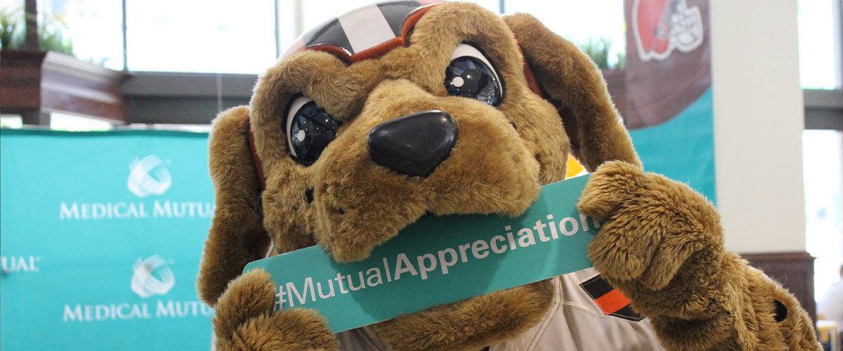 Cleveland Browns mascot, Chomps holding a sign that reads "#MutualAppreciation".