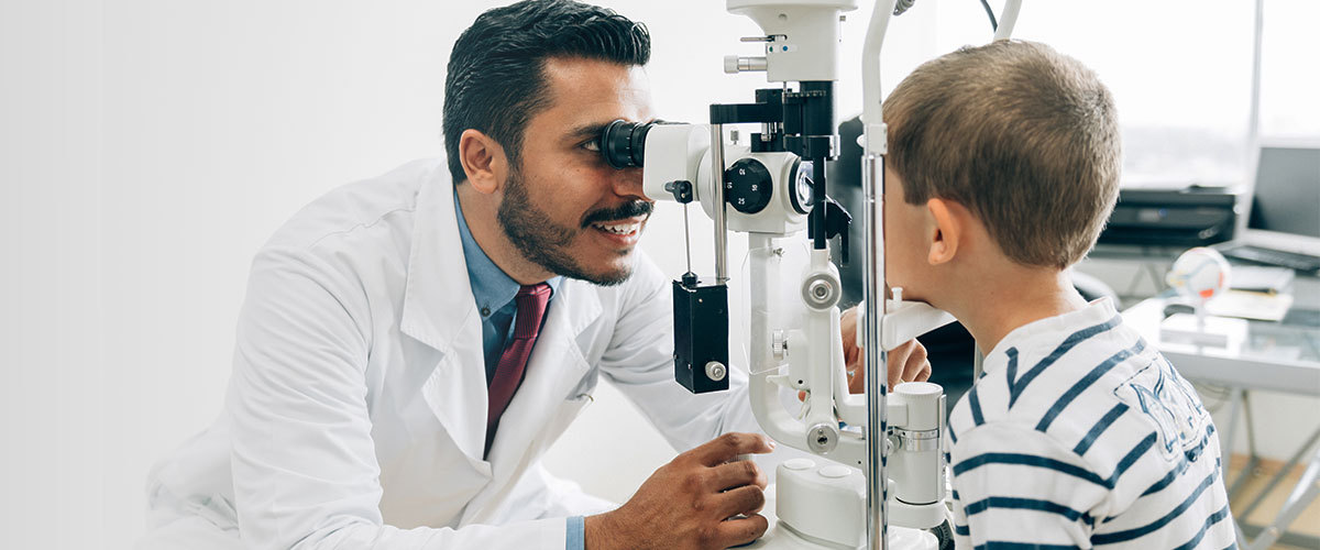 Child and an optometrist during an eye exam.