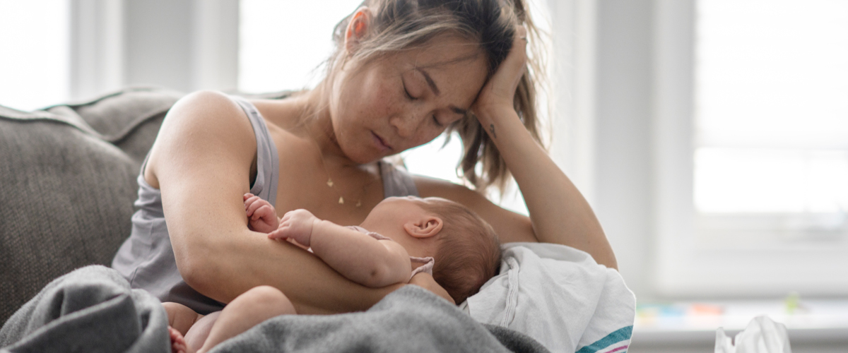 A mother holding her young baby.