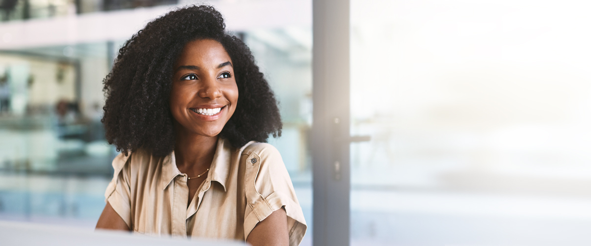 Young woman smiling in an office building.
