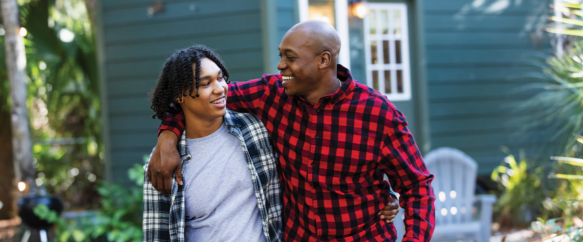 Parent and child walking arm in arm.