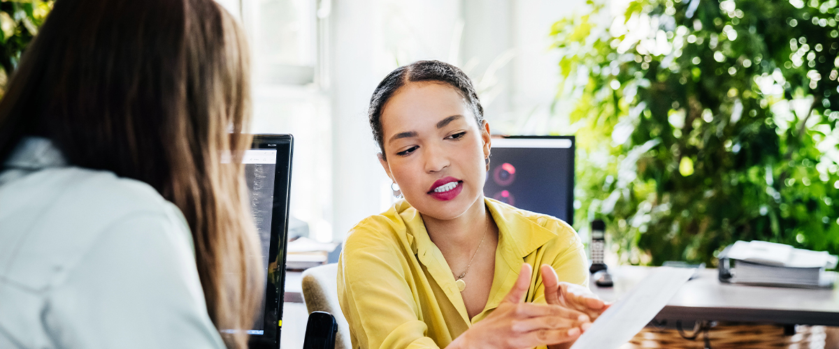 Two women collaborating in an office building.