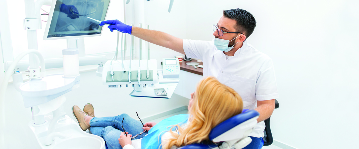A dentist going over results with a patient.