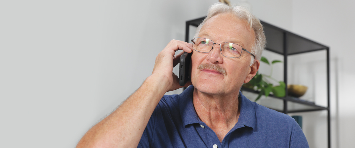 Senior man talking on cell phone.