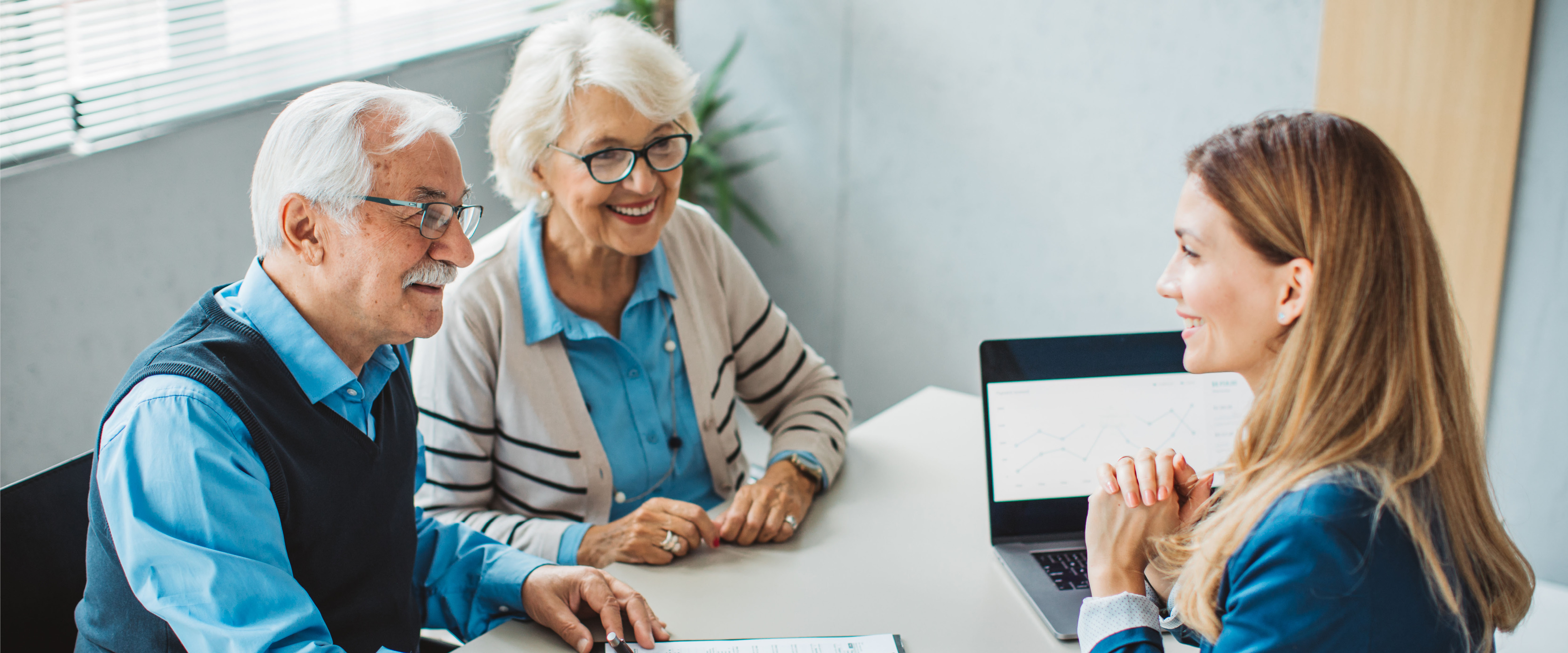 Older couple meeting with a business professional in an office.