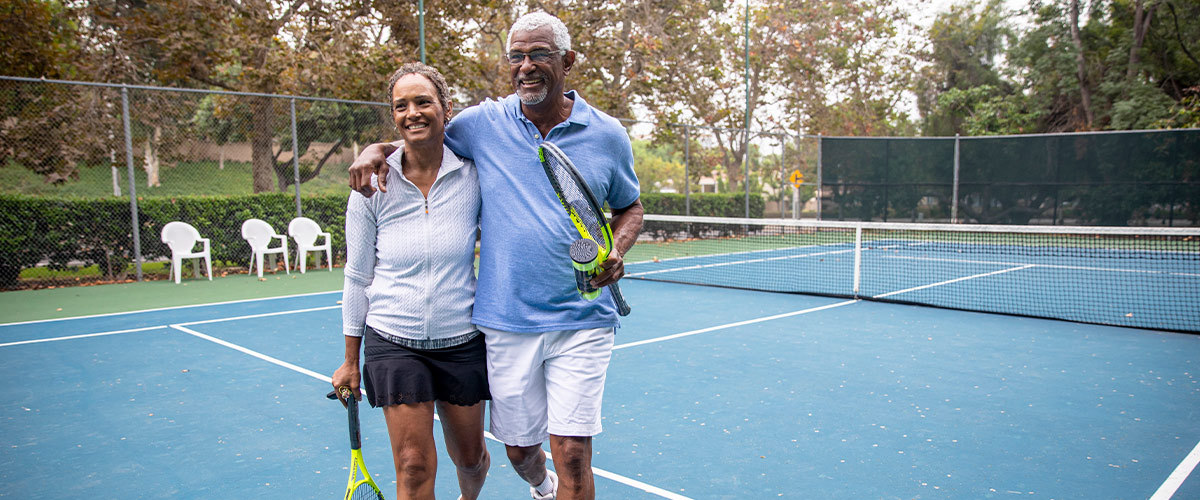 Senior couple playing tennis.