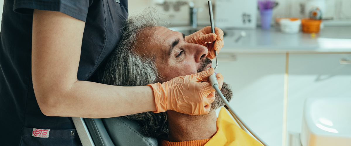 Senior man getting a dental check.
