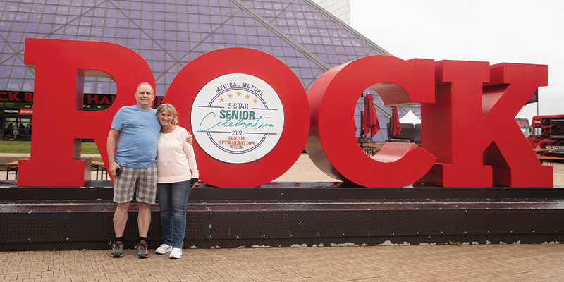 Couple standing in front of Rock and Roll Hall of Fame
