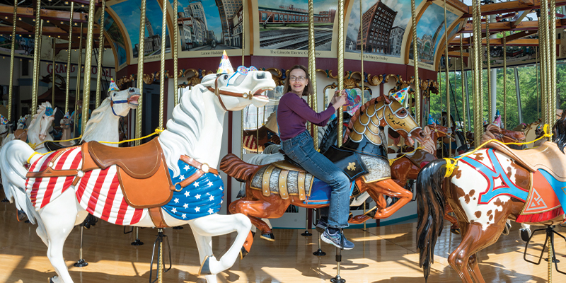 Senior woman riding carousel