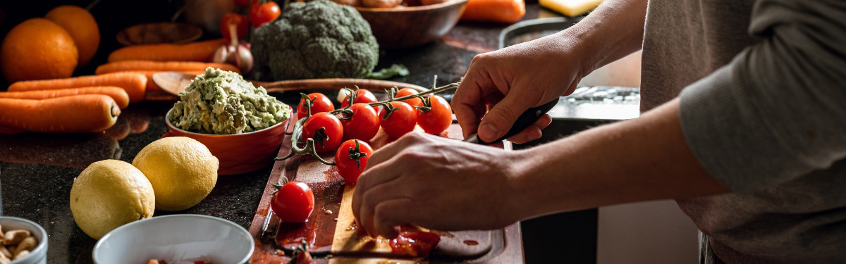 Vegetables being chopped on a cutting board.