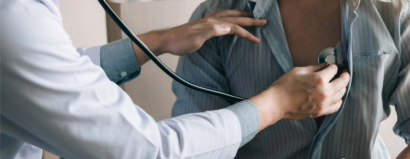Photo of doctor using stethoscope on patient