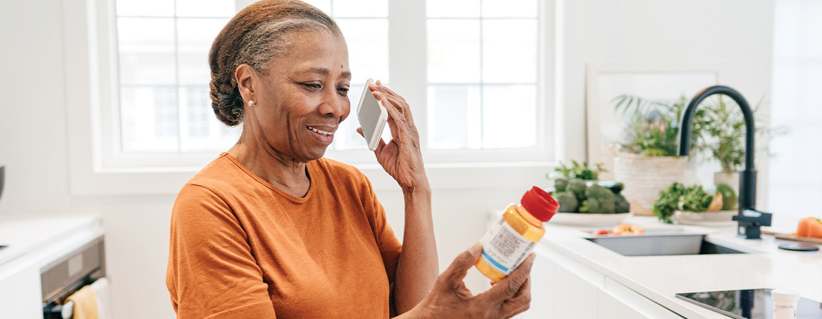 Photo of woman looking at pill bottle
