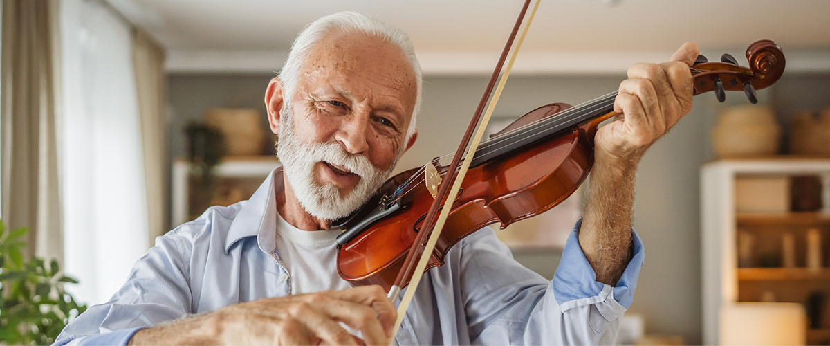 Person playing a violin indoors.