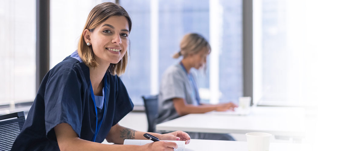 Nursing student sitting at a desk.