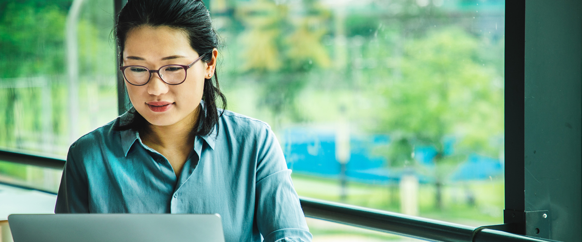 A woman working on a laptop.